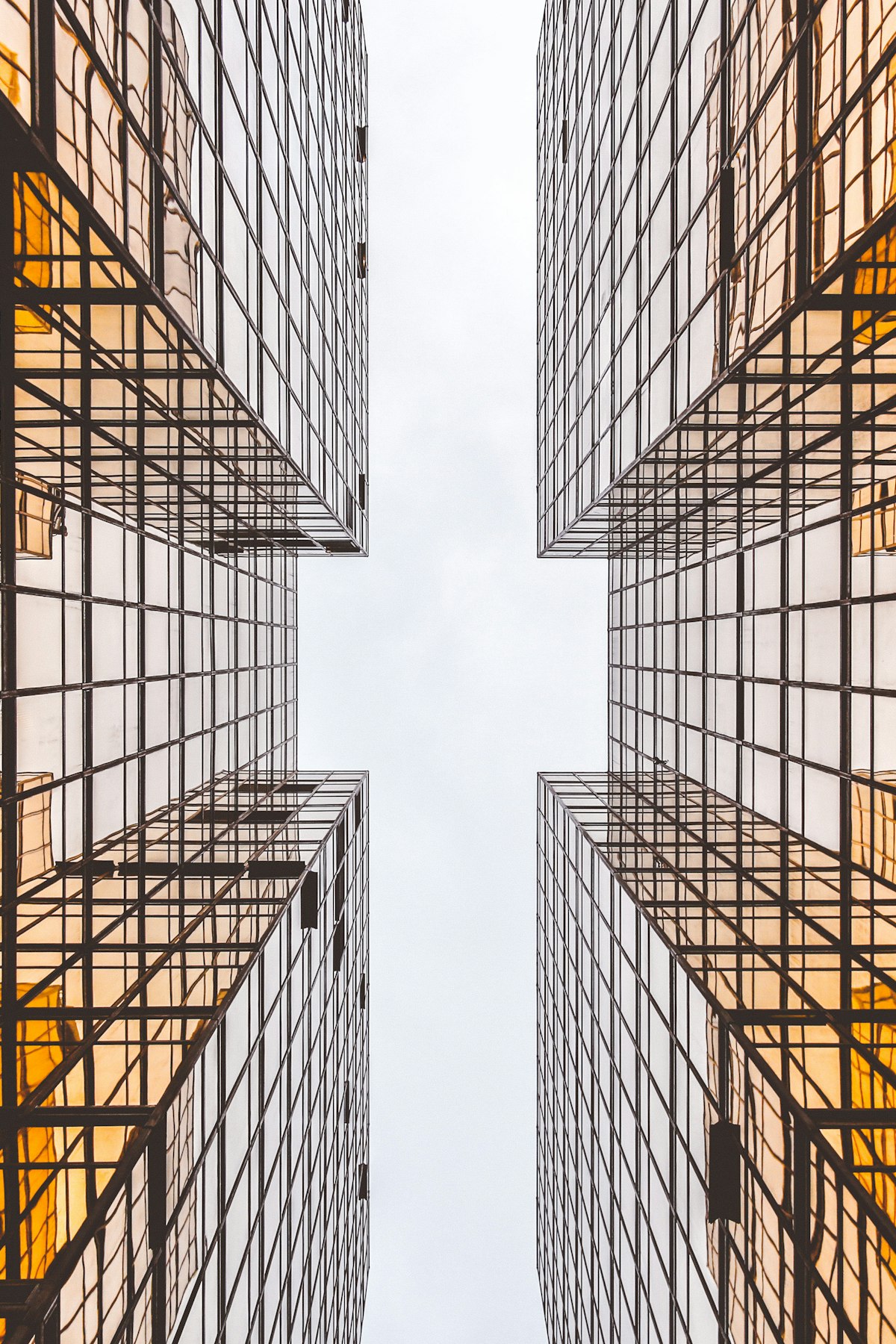 Glass corporate towers converging toward an open sky